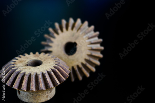 Bevel Gears working at wood on a black background