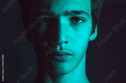 Portrait of a young man. Portrait of a handsome man, looking in the camera. Closeup face of a caucasian teenage boy. Confident and serious look of a teenager