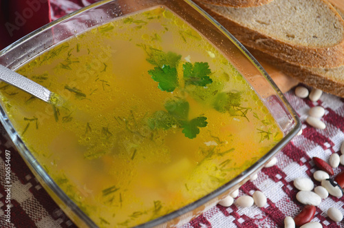 Winter soup with beans, carrots, potatoes and seasonings, top view. Typical Tuscan ribollite soup. photo