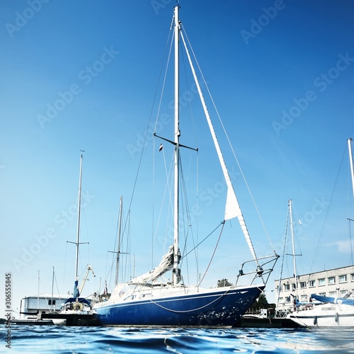 View of a moored yacht in Riga yachtclub from a water level on a clear sunny day photo