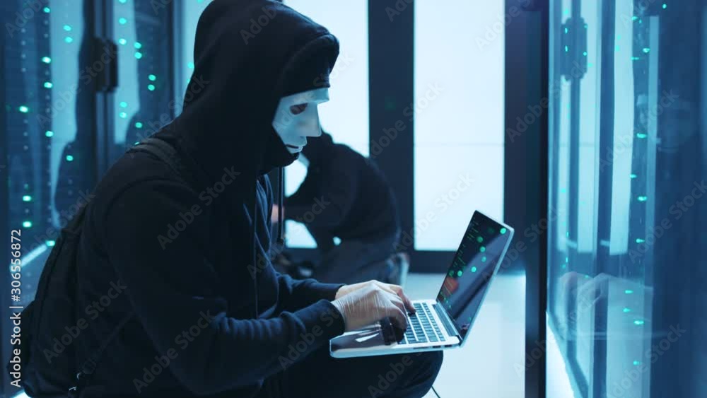 Group of malicious hackers breaking into server room of database, typing spyware coding programs on laptop to steal big data, cooperating and leaving. Dangerous cybercrime. Group of malicious hackers breaking into server room of database, typing spyware coding programs on laptop to steal big data, cooperating and leaving. Dangerous cybercrime.