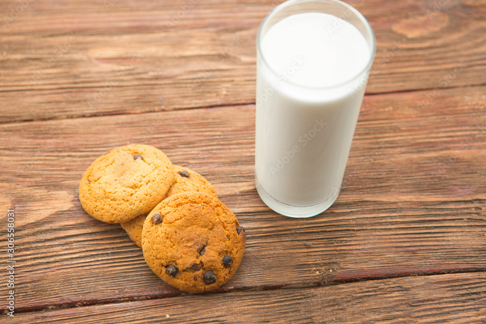 Cookies and glass of milk on wooden table Cookies and glass of milk on wooden table