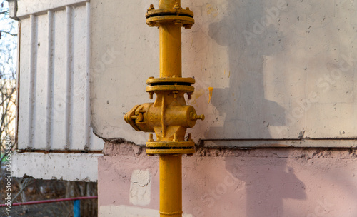 Yellow valve with flanges on the vertical pipeline