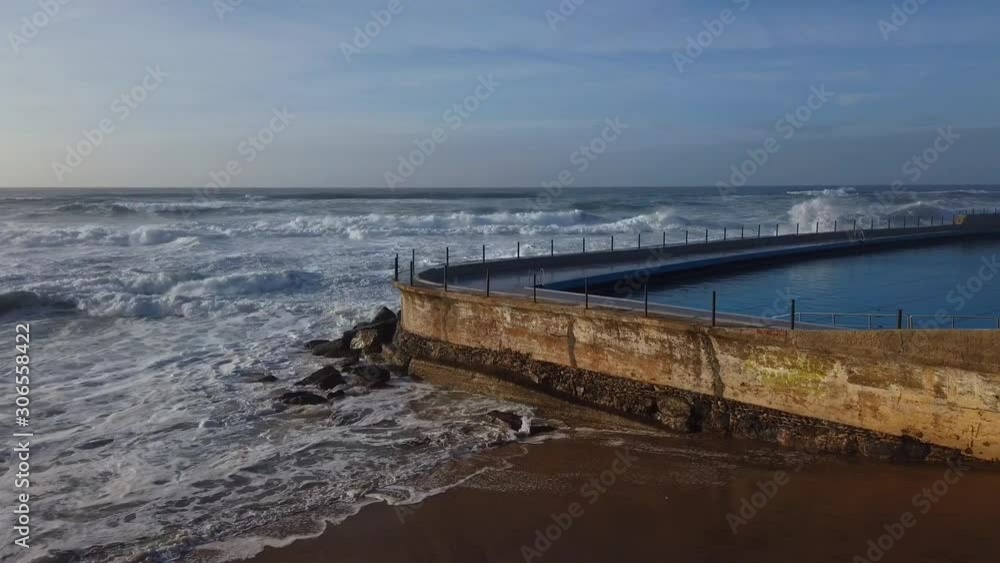 Big ocean wave splashing against a ocean pool. Massive waves. Big ocean wave splashing against a ocean pool. Massive waves.