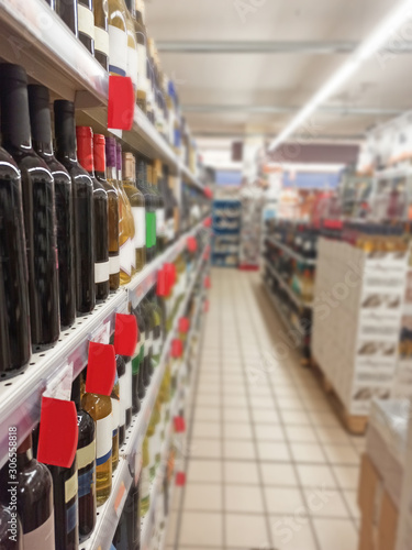 Wine bottles on display in the supermarket shelves
