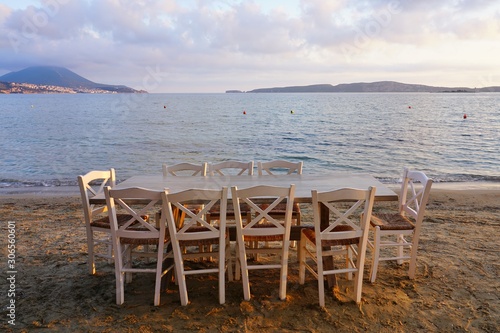 Table set on the beach at a traditional Greek taverna in Gialova on the Navarino Bay in Messinia in the Peloponnese region of Greece near Pylos © eqroy