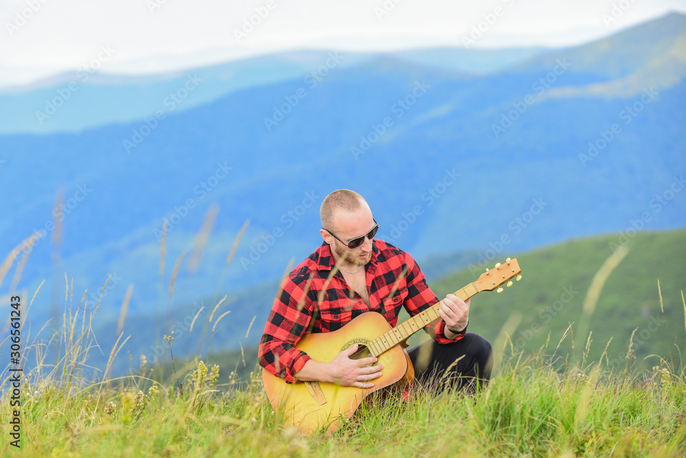 In unison with nature. Musician hiker find inspiration in mountains. Keep calm and play guitar. Man with guitar on top of mountain. Acoustic music. Music for soul. Playing music. Sound of freedom In unison with nature. Musician hiker find inspiration in mountains. Keep calm and play guitar. Man with guitar on top of mountain. Acoustic music. Music for soul. Playing music. Sound of freedom