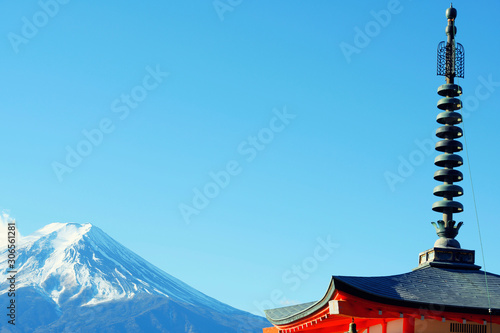 Canvas Print Mountain Fuji with snow on top, and red traditional Japanese temple tower over blue sky background, Japan