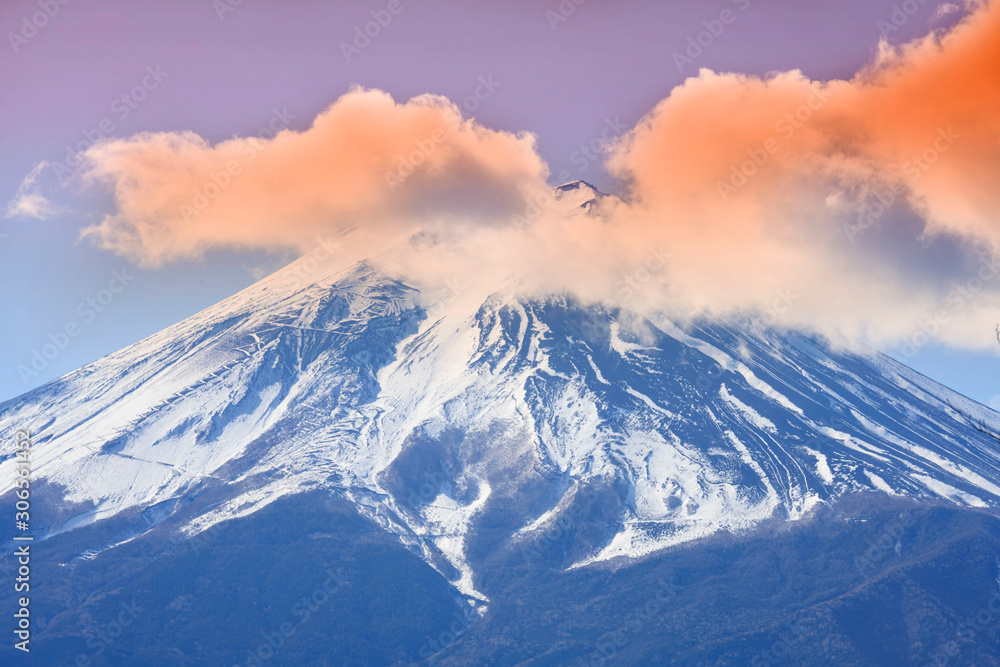 Colorful clouds covered top of Fuji mountain with snowflake over blue sky, Japan.
