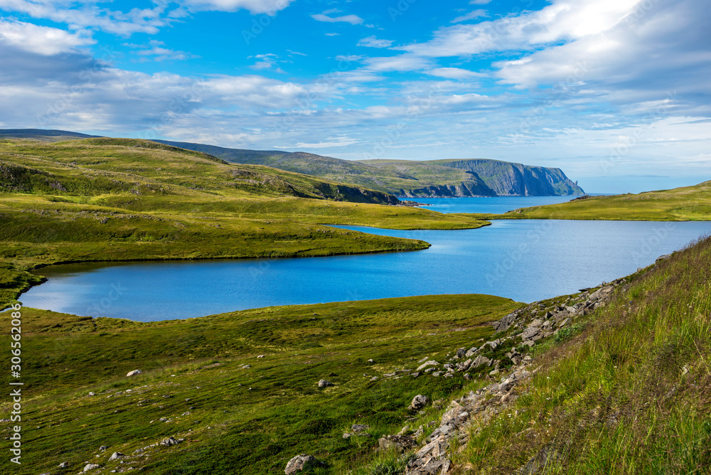 Storvatnet lake in Mageroya island. The coastline of the Barents Sea in Nord Cape direction is at background. Nordkapp Municipality in Norwegian Finnmark county.