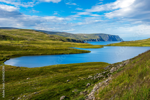 Storvatnet lake in Mageroya island. The coastline of the Barents Sea in Nord Cape direction is at background. Nordkapp Municipality in Norwegian Finnmark county. © sasha64f