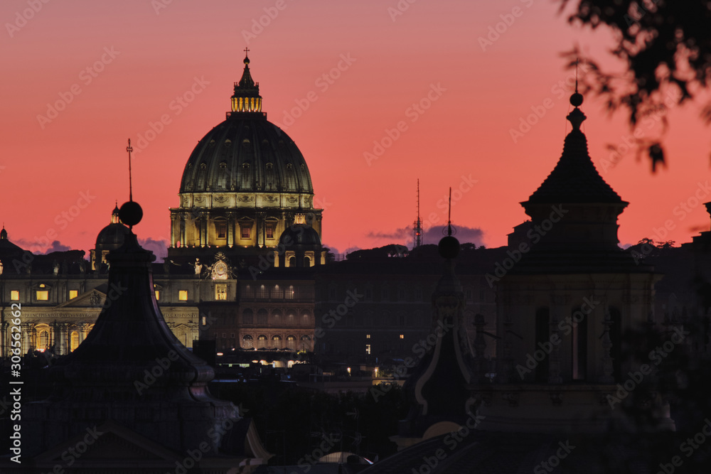 Rome, Italy - Dome of St Peter Basilica at sunset on a background of red sunset sky