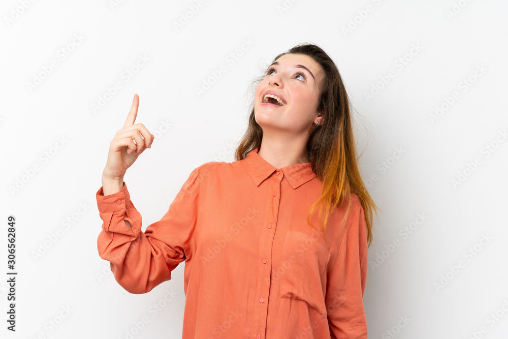 Young brunette girl over isolated white background pointing up and surprised Young brunette girl over isolated white background pointing up and surprised