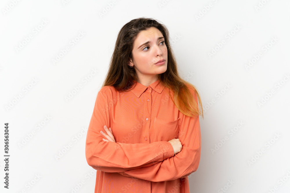 Young brunette girl over isolated white background making doubts gesture while lifting the shoulders Young brunette girl over isolated white background making doubts gesture while lifting the shoulders
