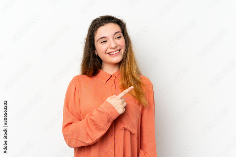 Young brunette girl over isolated white background pointing to the side to present a product Young brunette girl over isolated white background pointing to the side to present a product