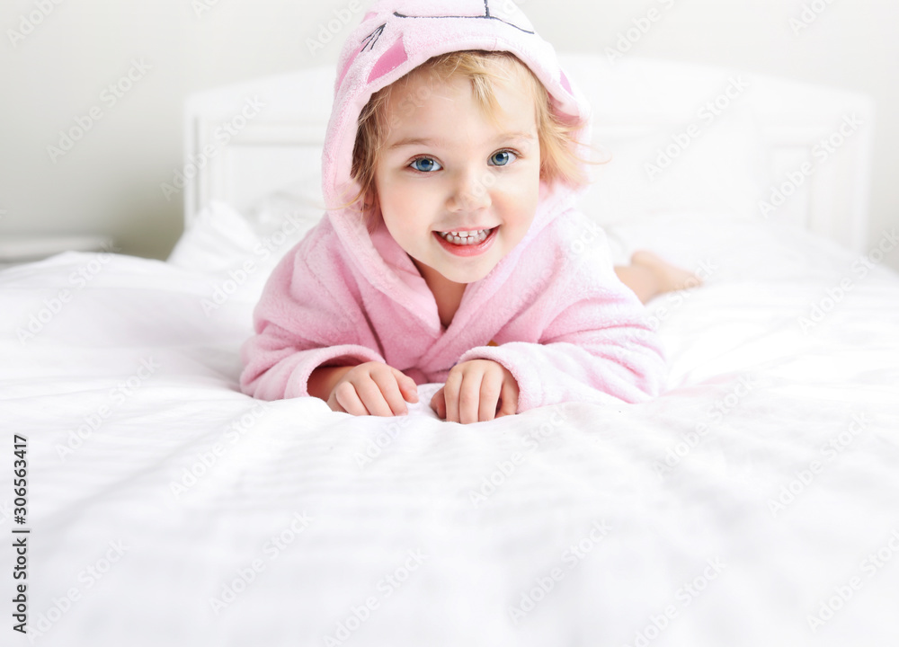 Caucasian child in bathrobe lying in bed,kid hygiena empty space. Caucasian child in bathrobe lying in bed,kid hygiena empty space.