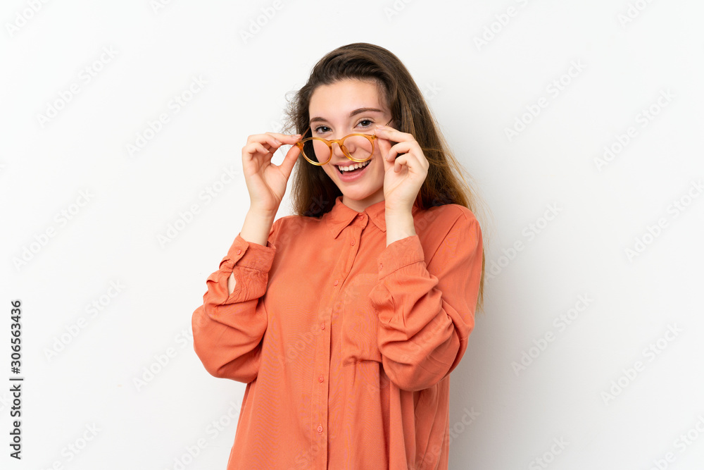 Young brunette girl over isolated white background with glasses and surprised Young brunette girl over isolated white background with glasses and surprised