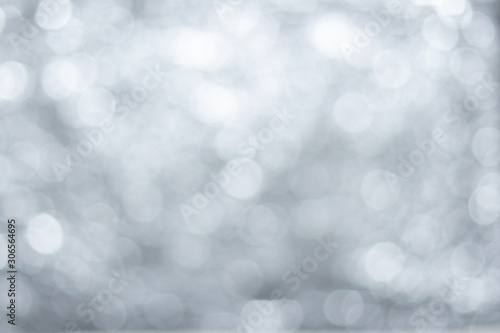 Abstract bokeh background, blurred light on silver white