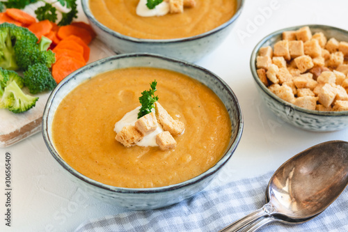 Cream vegetable soup broccoli, carrot, cauliflower with croutons. Vegetarian healthy food on light background