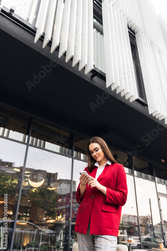 Businesswoman texting messages while walking.