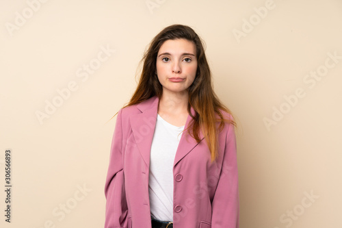 Young brunette girl with blazer over isolated background with sad and depressed expression © luismolinero