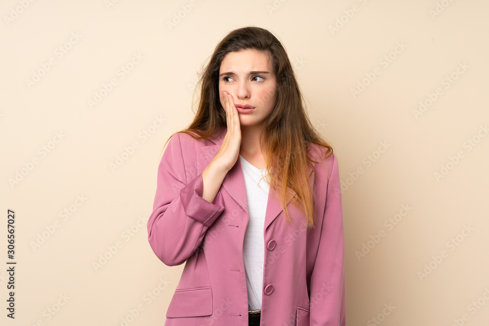 Young brunette girl with blazer over isolated background with toothache Young brunette girl with blazer over isolated background with toothache