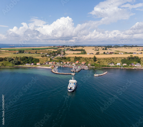 Uraniborg ferry arriving to the harbor in the village of Bäckviken on the island of Ven in southern Sweden during a warm summer day in tourist season. 