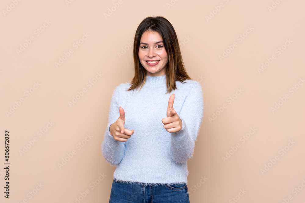 Young woman over isolated background pointing to the front and smiling Young woman over isolated background pointing to the front and smiling