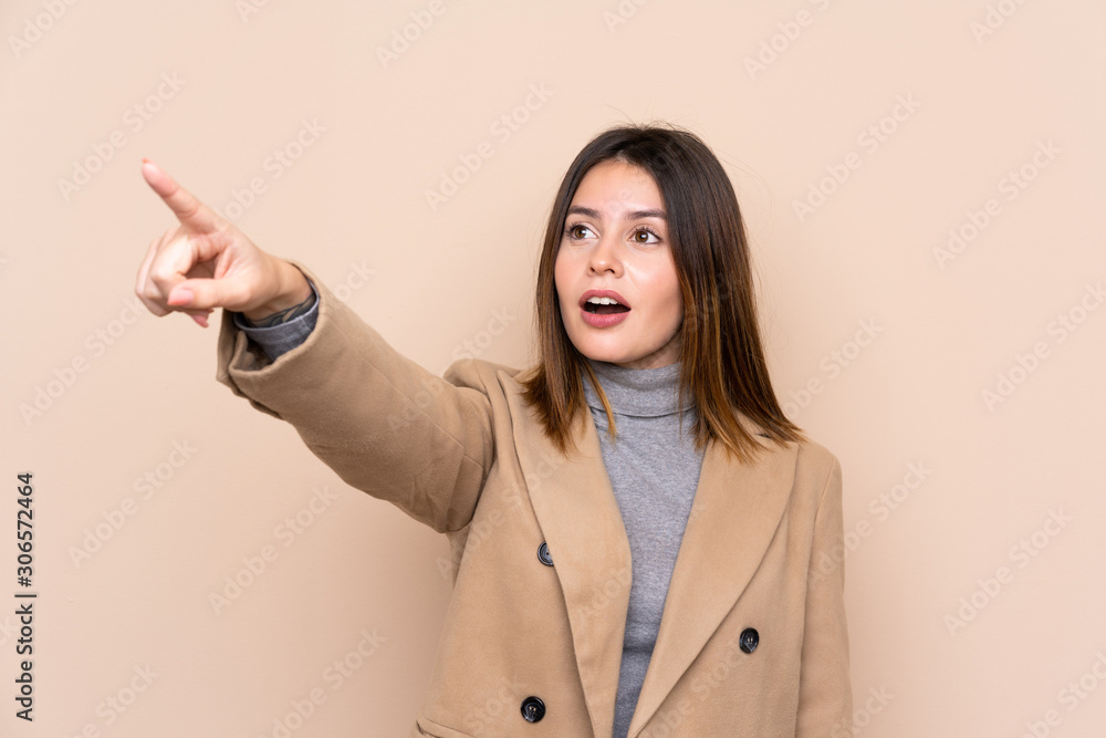 Young woman over isolated background pointing away Young woman over isolated background pointing away