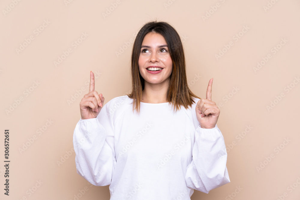 Young woman over isolated background pointing with the index finger a great idea Young woman over isolated background pointing with the index finger a great idea