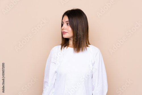 Young woman over isolated background looking side