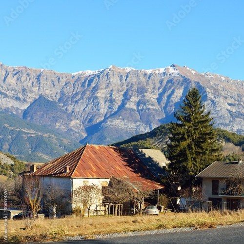 A small village near the road in french Alps near lac de serre-poncon on a sunny day. Ecrins massif photo