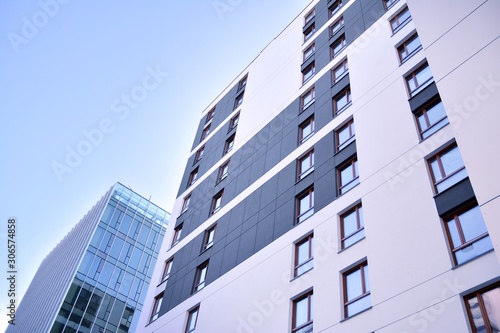Fragment of modern residential apartment with flat buildings exterior. Detail of new luxury house and home complex. 