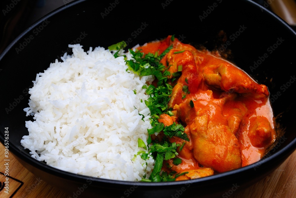 Chicken tikka masala served with white basmati rise and herbs Chicken tikka masala served with white basmati rise and herbs