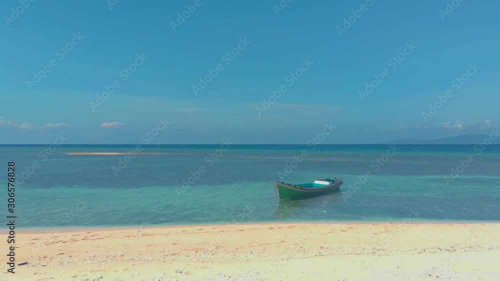 4K Tropical landscape of white sandy beach and coral reefs. Small boat surrounded by azure water and coral reefs in the white coast of Pink island in Balabac, Philippines 4K Tropical landscape of white sandy beach and coral reefs. Small boat surrounded by azure water and coral reefs in the white coast of Pink island in Balabac, Philippines