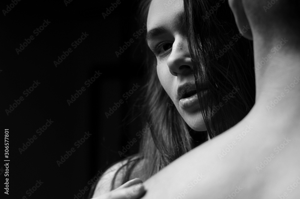 Naklejka premium Beautiful couple embracing and fashion posing in studio