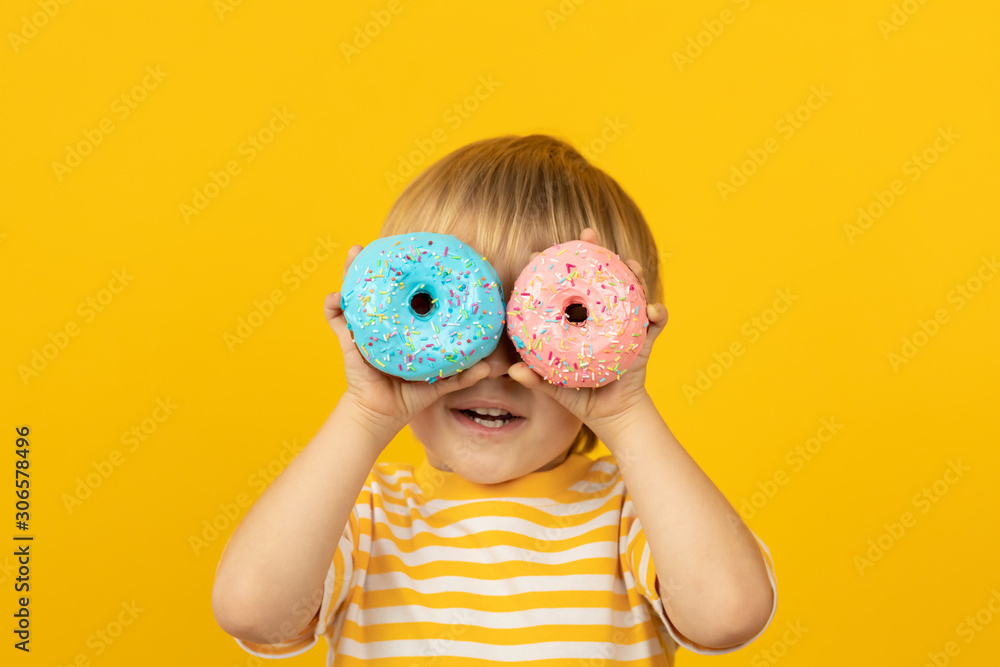 Happy child holding glazed donut