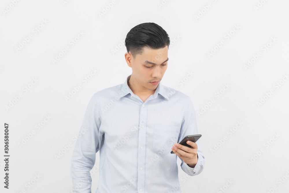 Young handsome asian business man playing smartphone and thinking isolated on white background. Young handsome asian business man playing smartphone and thinking isolated on white background.