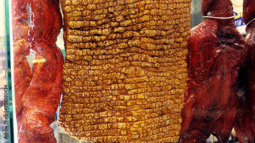 Pork belly and duck hanging close up