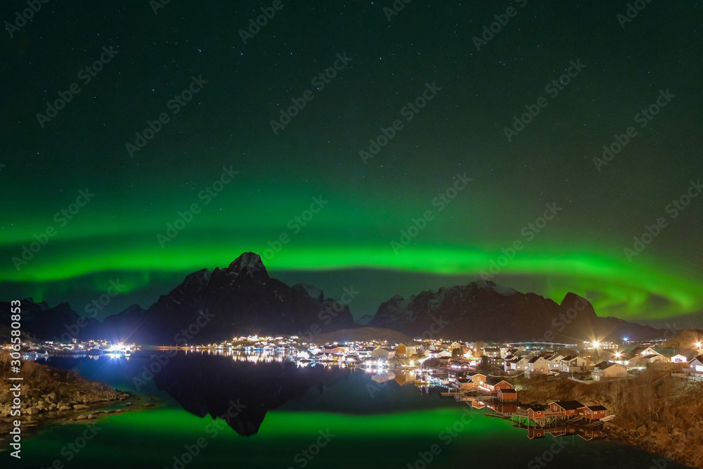 Reine fishing village with the northern lights, Aurora Borealis, mountains in the background, Lofoten Islands, Norway