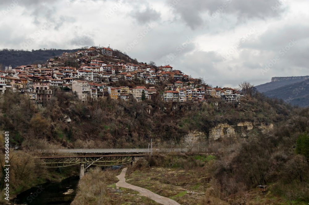 View of a residential neighborhood with old houses interestingly situated next to each other on a steep hill and bridge over Yantra river in Veliko Tarnovo, the old capital of Bulgaria, Europe 
