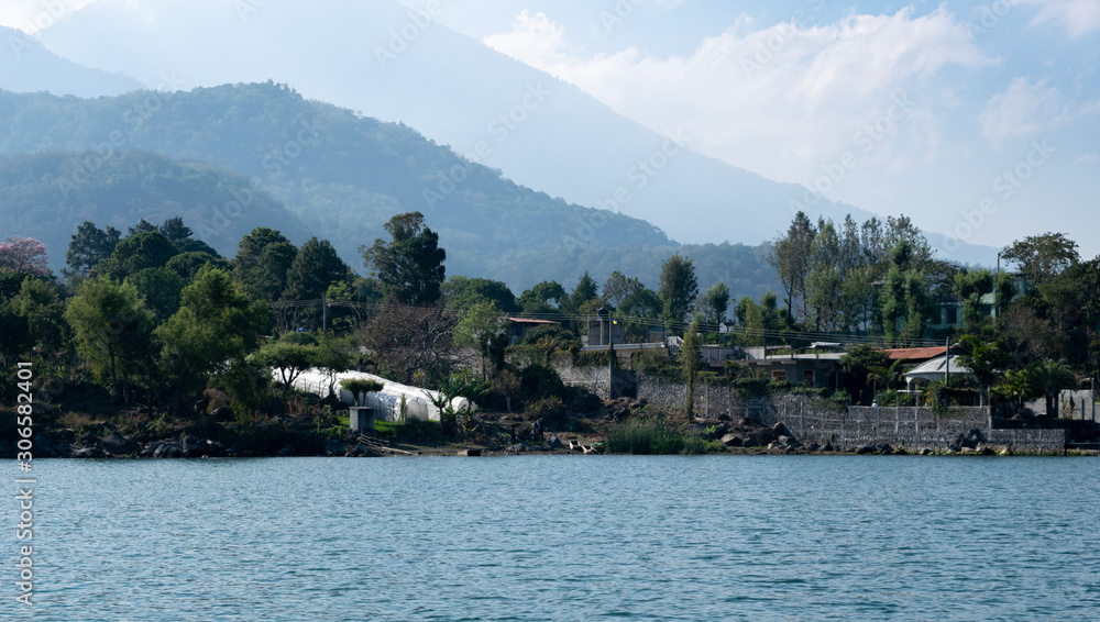 Fototapeta premium Shoreline with mountains behind at Lake Atitlan