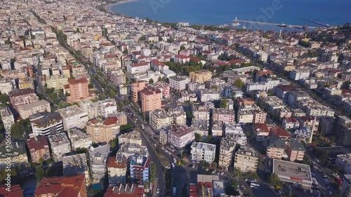 Aerial breathtaking view of the ocean coast and the city houses on cloudy blue sky background. Art. Amazing landscape with the ocean shore and the city streets.