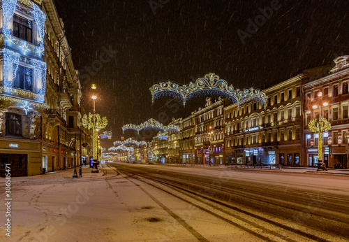 Snow-covered and decorated for the New year Nevsky prospect in the early December morning.