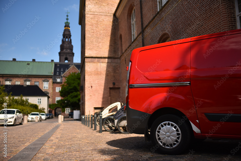 red commercial van in old european city