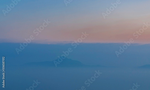 Photography Blue mountains covered with solid fog on the background of the bright sunrise