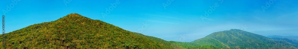 Panoramic view of the mountainous tropical coast covered with rainforest, panorama from a several shots. Panoramic view of the mountainous tropical coast covered with rainforest, panorama from a several shots.