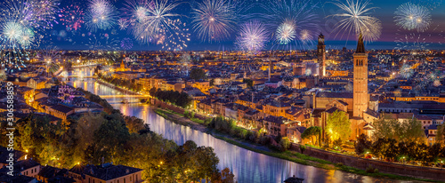 Canvas Print Celebration of New Year's Eve with flashing fireworks above Verona city, Italy,