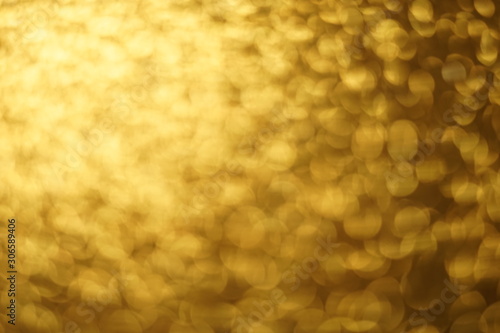Golden shiny background, gold sparkles blurred background.