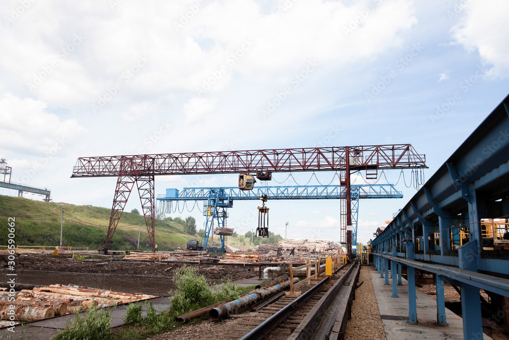 The work of a gantry crane in the plywood factory The work of a gantry crane in the plywood factory